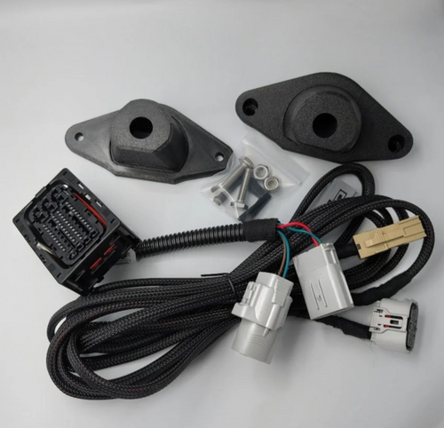 CAN bus adapter harness with factory connectors and camera mount bezels, included in the GG Offroad Tacoma tailgate-removed backup camera relocation kit